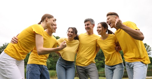 Photo of Team building. Group of happy people together outdoors