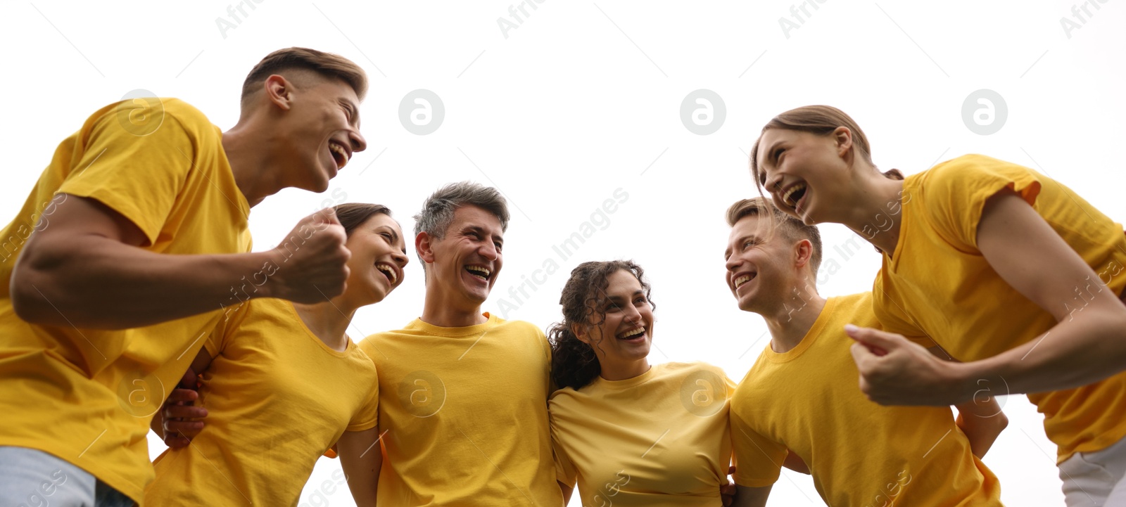 Photo of Team building. Group of happy people together outdoors, low angle view