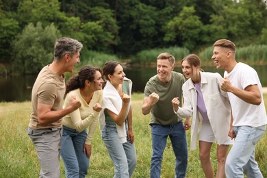 Photo of Team building. Group of happy people together outdoors