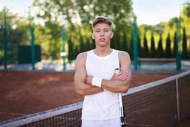 Photo of Portrait of handsome man at tennis court