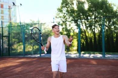 Photo of Young man playing tennis at court on sunny day