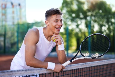 Photo of Young man with racket at tennis court