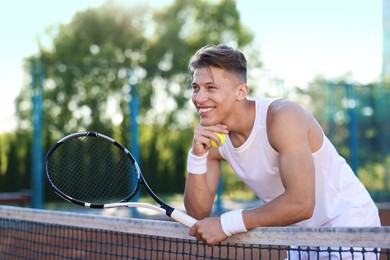 Photo of Young man with racket at tennis court