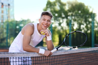 Photo of Young man with racket at tennis court