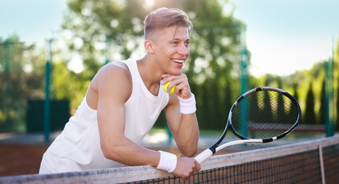 Photo of Young man with racket at tennis court