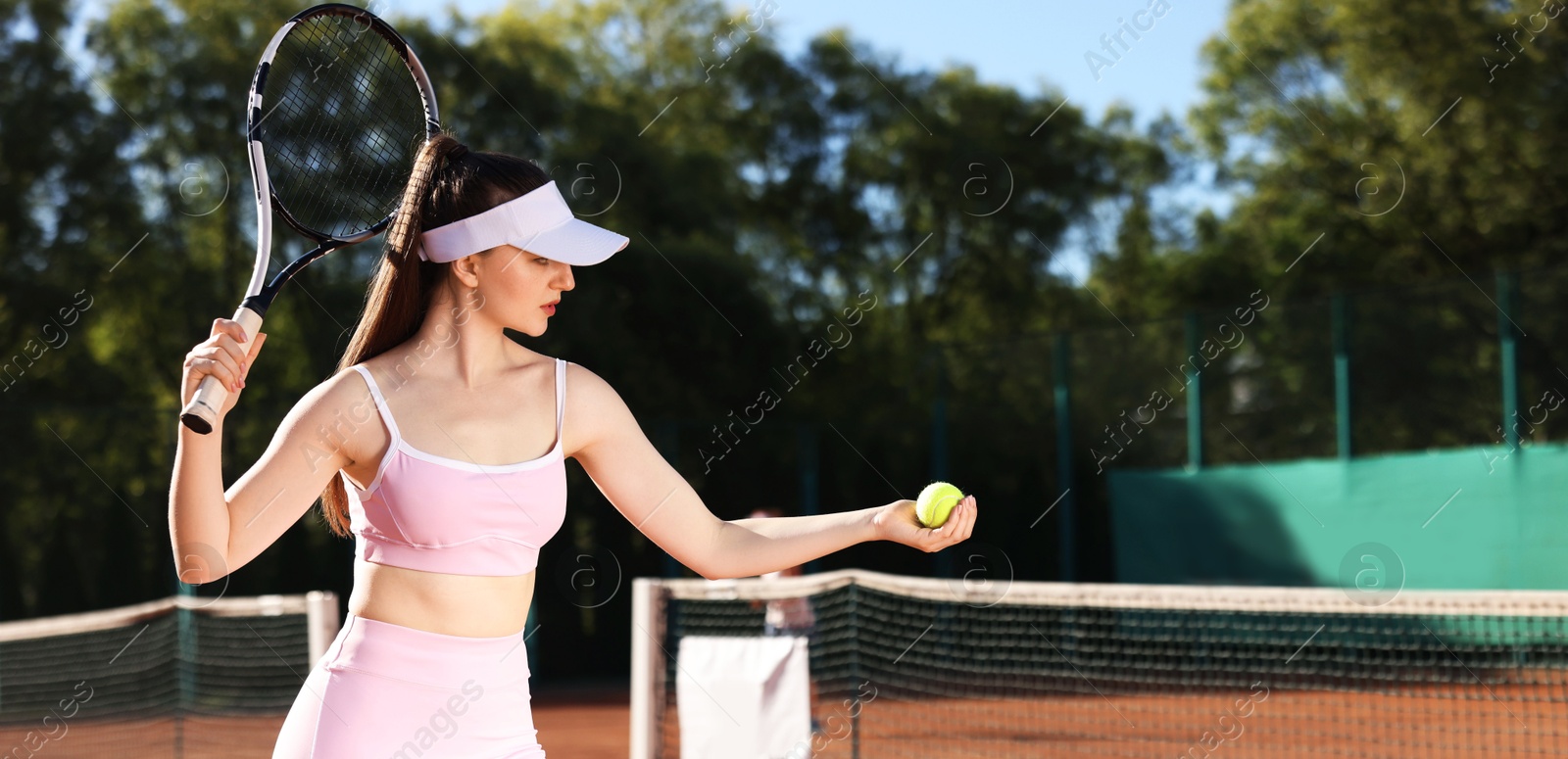 Young woman playing tennis at court on sunny day. Space for text Photo of Young woman playing tennis at court on sunny day. Space for text