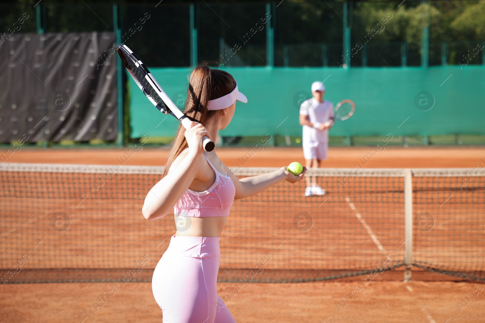 Woman and man playing tennis at court Photo of Woman and man playing tennis at court