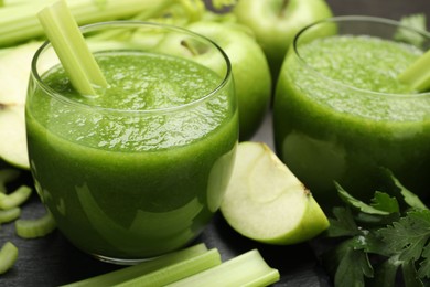 Photo of Superfood. Refreshing smoothie in glasses and ingredients on dark textured table, closeup