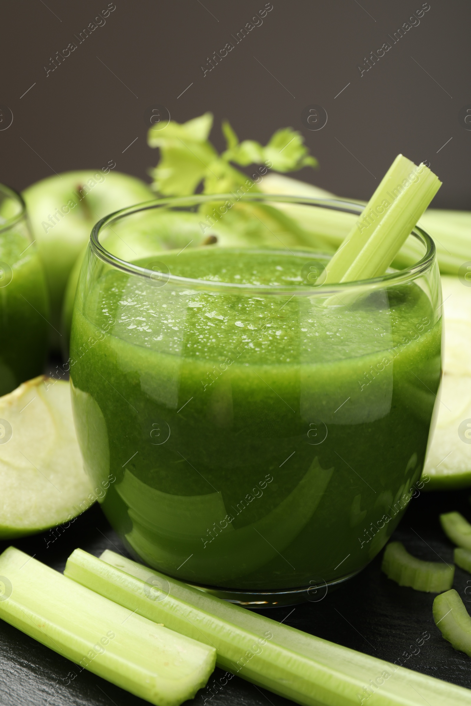 Superfood. Refreshing smoothie in glass and ingredients on dark textured table against grey background, closeup Photo of Superfood. Refreshing smoothie in glass and ingredients on dark textured table against grey background, closeup