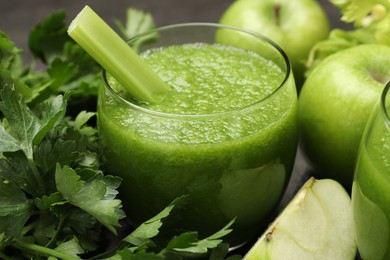 Photo of Superfood. Refreshing smoothie in glass and ingredients on dark table, closeup