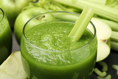 Photo of Superfood. Refreshing smoothie in glass and ingredients on dark table, closeup