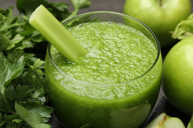 Photo of Superfood. Refreshing smoothie in glass and ingredients on dark table, closeup