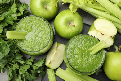 Photo of Superfood. Refreshing smoothie in glasses and ingredients on dark textured table, flat lay