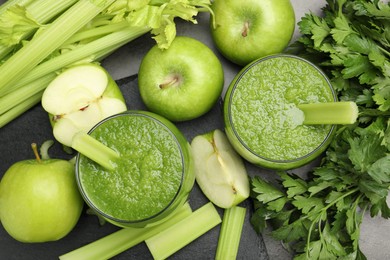 Photo of Superfood. Refreshing smoothie in glasses and ingredients on dark textured table, flat lay