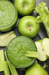 Photo of Superfood. Refreshing smoothie in glasses and ingredients on dark table, flat lay