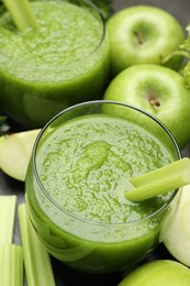 Photo of Superfood. Refreshing smoothie in glasses and ingredients on dark table, closeup