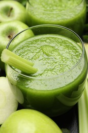 Photo of Superfood. Refreshing smoothie in glass and apples on dark table, closeup