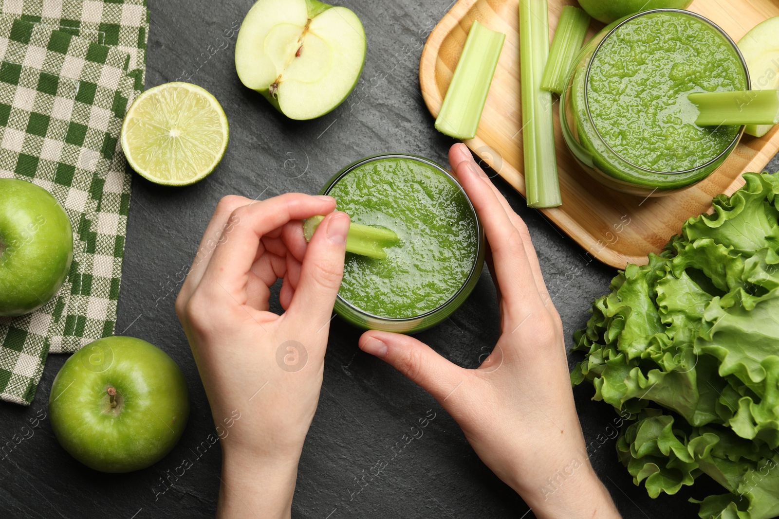 Superfood. Woman with glass of refreshing smoothie and ingredients at dark textured table, top view Photo of Superfood. Woman with glass of refreshing smoothie and ingredients at dark textured table, top view