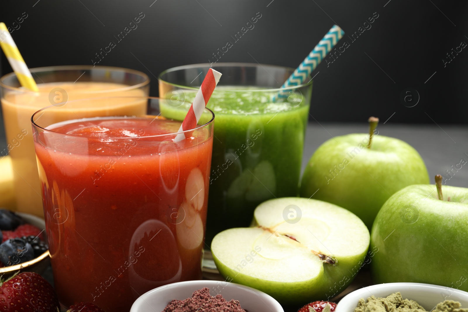 Superfood. Refreshing smoothies in glasses and ingredients on dark table, closeup Photo of Superfood. Refreshing smoothies in glasses and ingredients on dark table, closeup