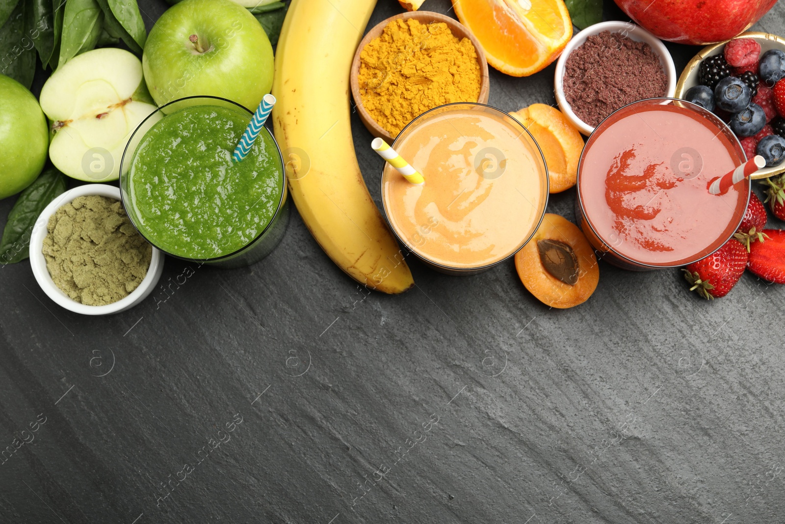 Superfood. Refreshing smoothies in glasses and ingredients on dark textured table, flat lay. Space for text Photo of Superfood. Refreshing smoothies in glasses and ingredients on dark textured table, flat lay. Space for text