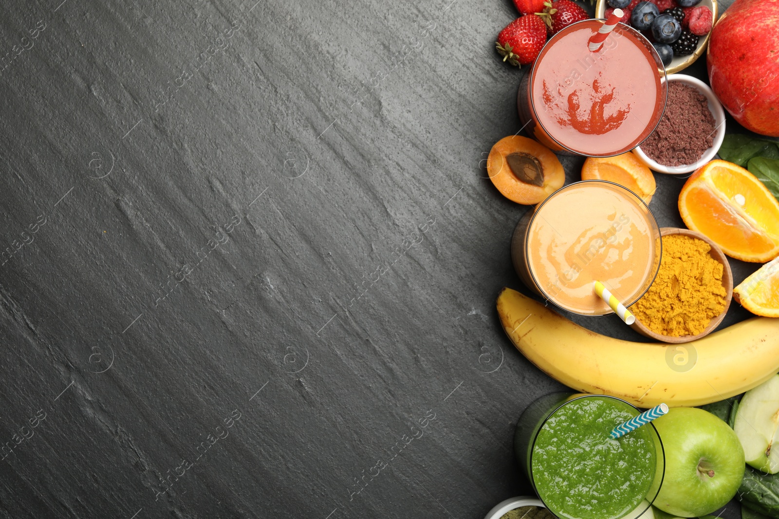 Superfood. Refreshing smoothies in glasses and ingredients on dark textured table, flat lay. Space for text Photo of Superfood. Refreshing smoothies in glasses and ingredients on dark textured table, flat lay. Space for text