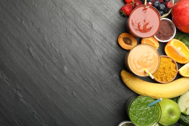 Photo of Superfood. Refreshing smoothies in glasses and ingredients on dark textured table, flat lay. Space for text