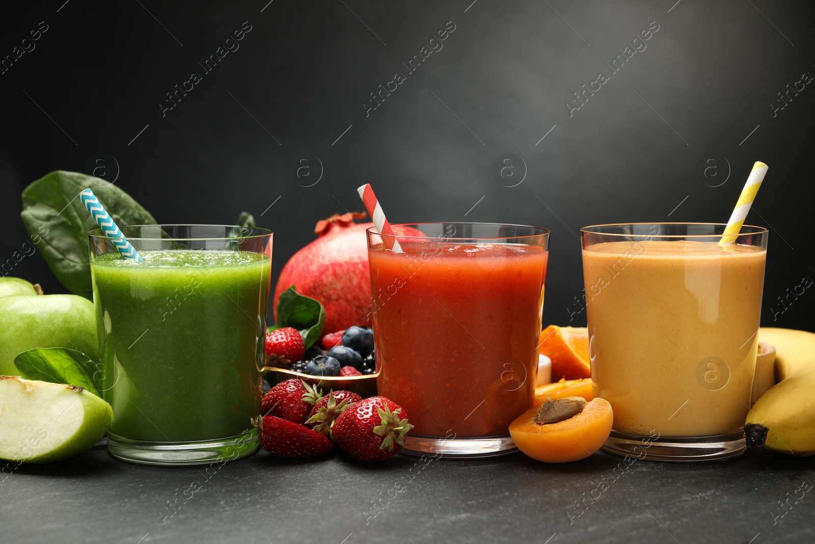 Superfood. Refreshing smoothies in glasses and ingredients on dark textured table, closeup Photo of Superfood. Refreshing smoothies in glasses and ingredients on dark textured table, closeup
