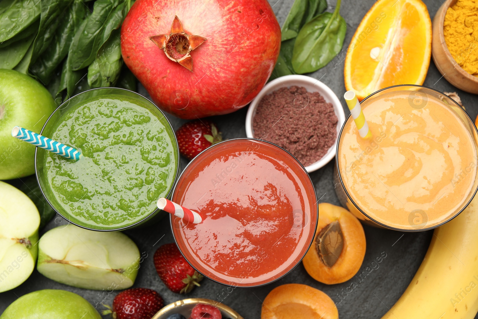 Superfood. Refreshing smoothies in glasses and ingredients on dark textured table, flat lay Photo of Superfood. Refreshing smoothies in glasses and ingredients on dark textured table, flat lay