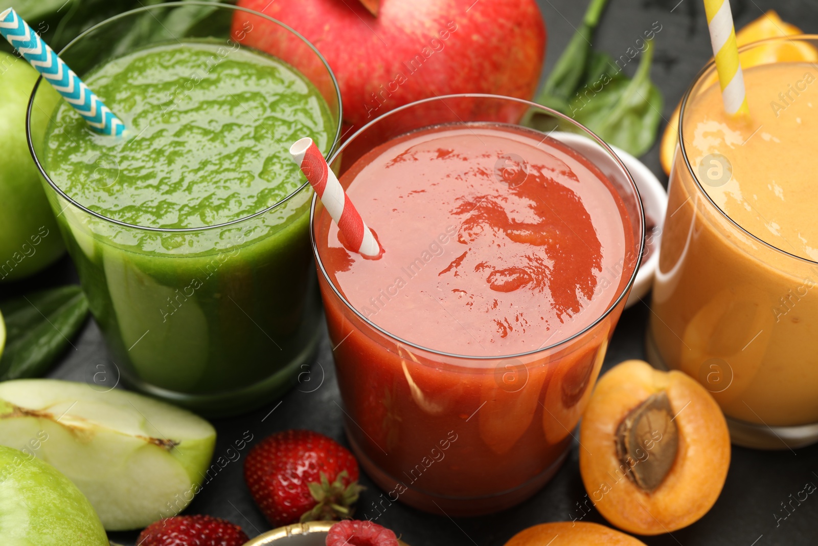 Superfood. Refreshing smoothies in glasses and ingredients on dark table, closeup Photo of Superfood. Refreshing smoothies in glasses and ingredients on dark table, closeup