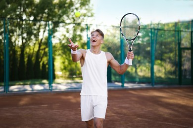 Photo of Young man playing tennis at court on sunny day