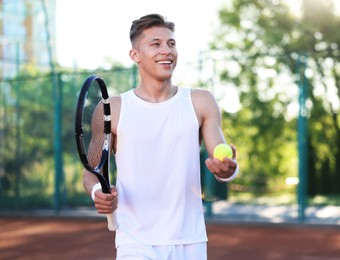 Photo of Young man playing tennis at court on sunny day