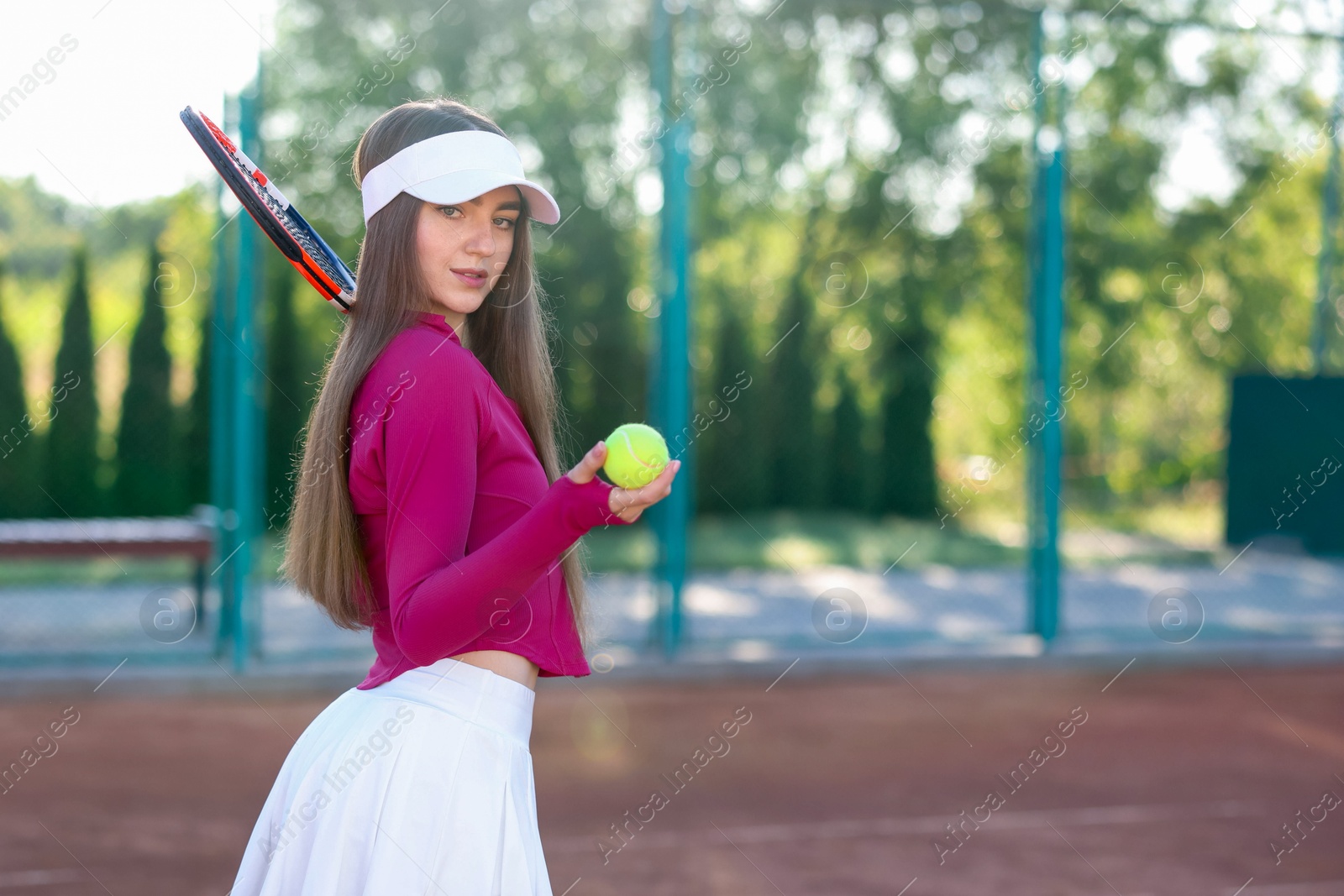 Beautiful woman with racket and ball at tennis court. Space for text Photo of Beautiful woman with racket and ball at tennis court. Space for text