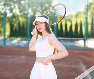 Photo of Beautiful woman with racket at tennis court