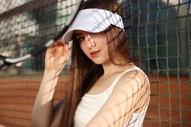 Photo of Beautiful woman with racket at tennis court
