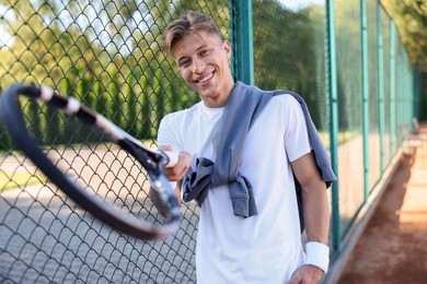 Photo of Young man with racket at tennis court