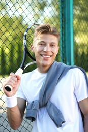 Photo of Young man with racket at tennis court