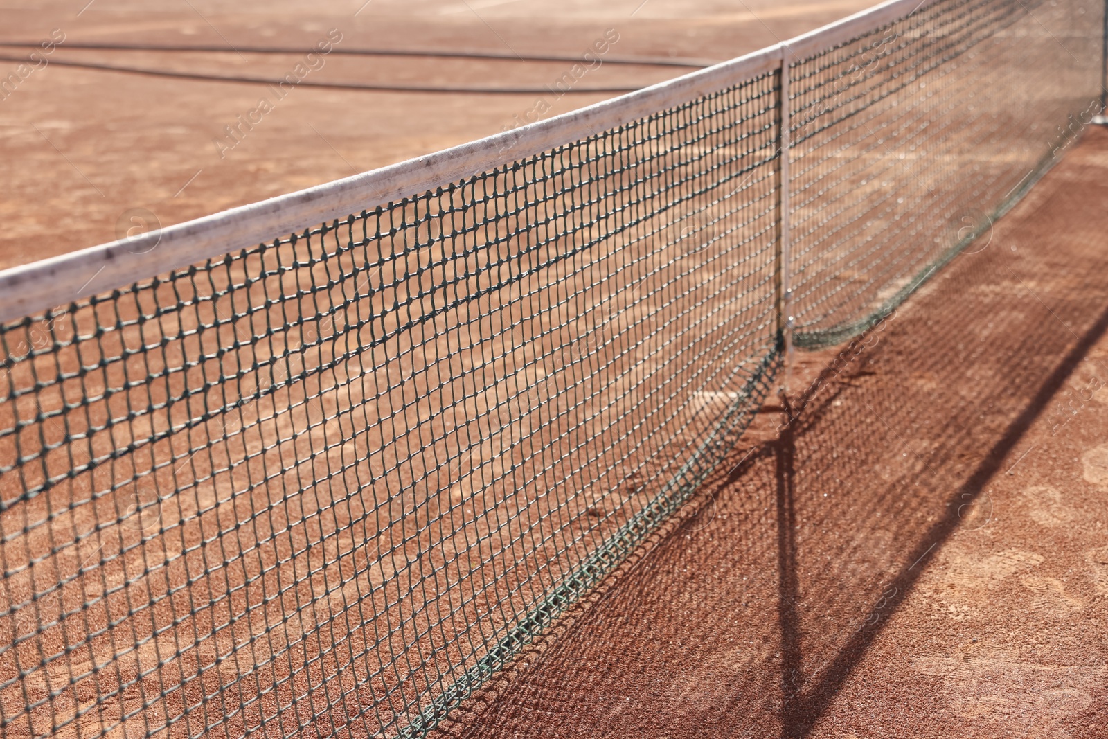 Tennis court with net on sunny day, closeup Photo of Tennis court with net on sunny day, closeup