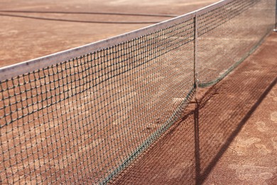 Photo of Tennis court with net on sunny day, closeup