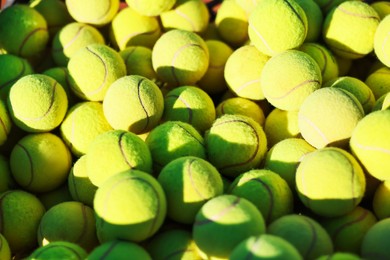 Photo of Many tennis balls in cart outdoors, closeup