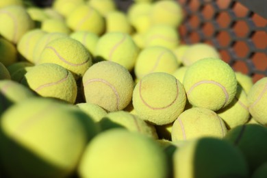 Photo of Many tennis balls in cart outdoors, closeup