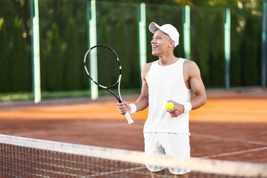 Photo of Young man playing tennis at court on sunny day