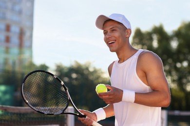 Photo of Young man playing tennis at court on sunny day