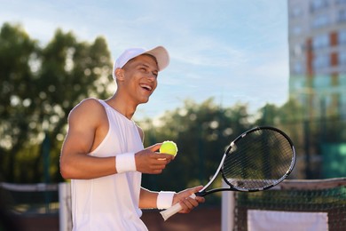 Photo of Young man playing tennis at court on sunny day