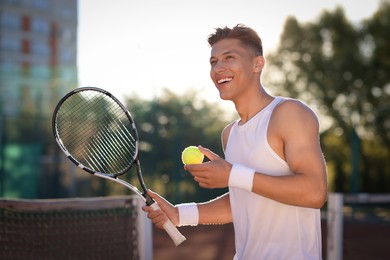 Photo of Young man playing tennis at court on sunny day