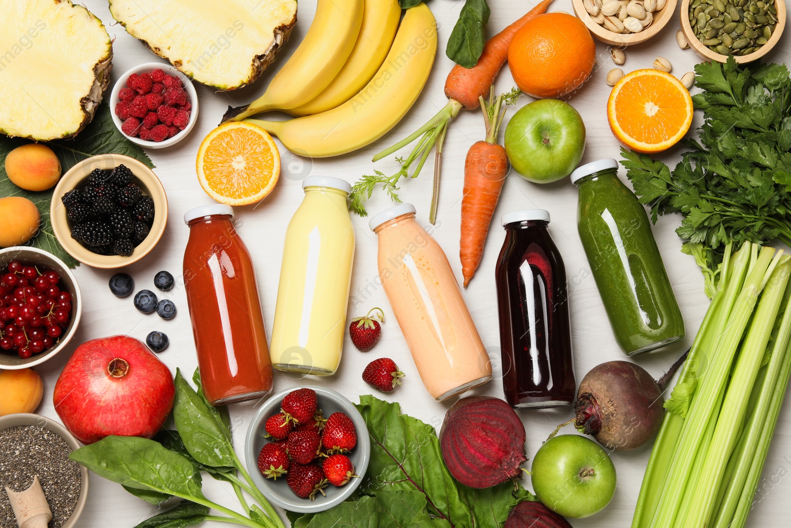 Superfood. Bottles with healthy drinks and ingredients on light wooden table, flat lay Photo of Superfood. Bottles with healthy drinks and ingredients on light wooden table, flat lay