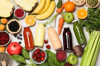 Photo of Superfood. Bottles with healthy drinks and ingredients on light wooden table, flat lay
