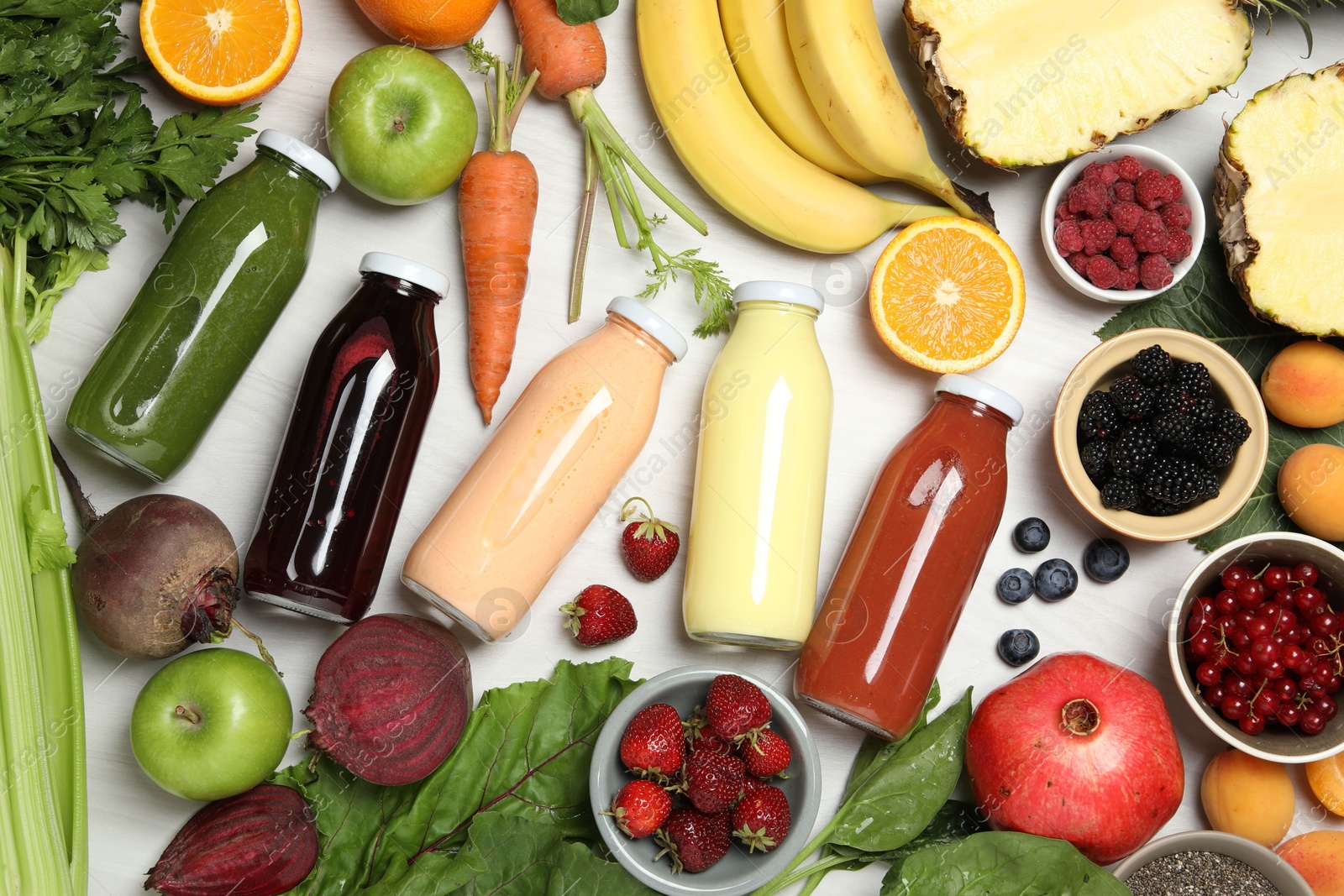 Superfood. Bottles with healthy drinks and ingredients on light wooden table, flat lay Photo of Superfood. Bottles with healthy drinks and ingredients on light wooden table, flat lay