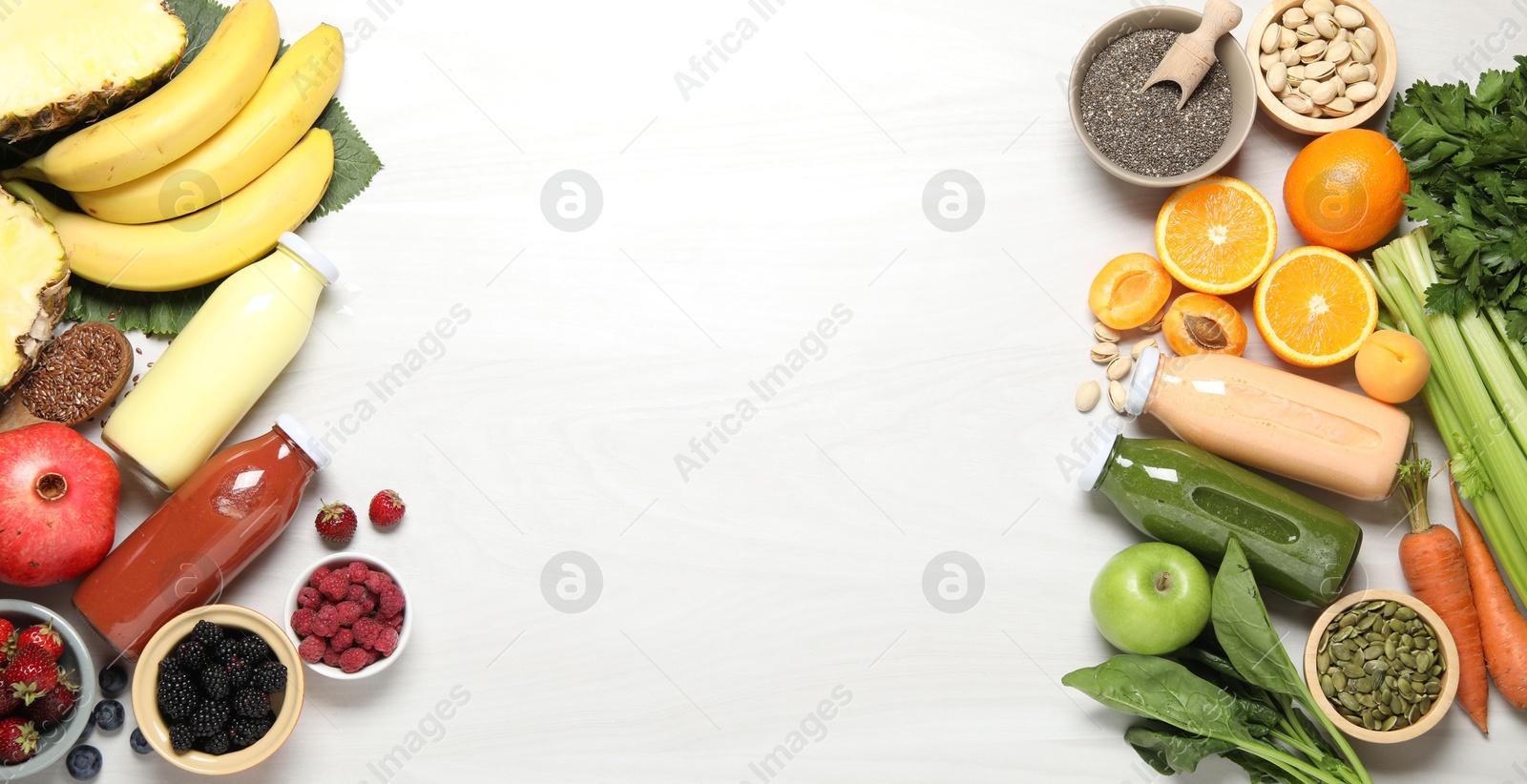 Superfood. Bottles with tasty smoothies and ingredients on light wooden table, flat lay. Space for text Photo of Superfood. Bottles with tasty smoothies and ingredients on light wooden table, flat lay. Space for text