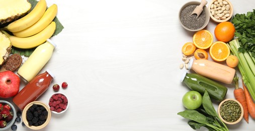 Photo of Superfood. Bottles with tasty smoothies and ingredients on light wooden table, flat lay. Space for text