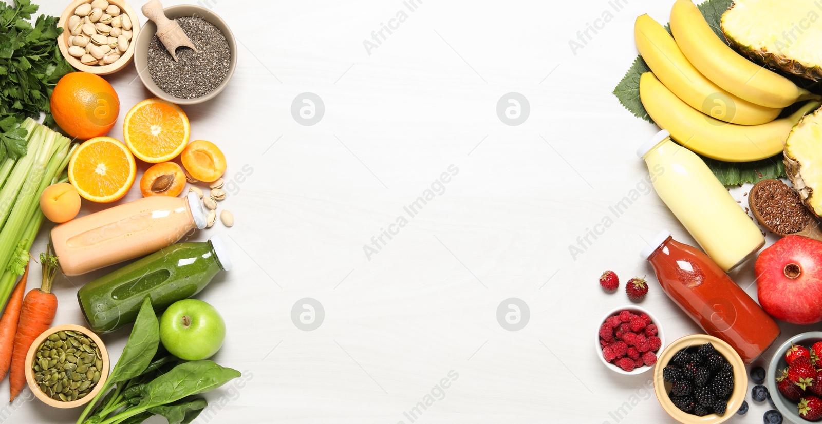 Superfood. Bottles with tasty smoothies and ingredients on light wooden table, flat lay. Space for text Photo of Superfood. Bottles with tasty smoothies and ingredients on light wooden table, flat lay. Space for text